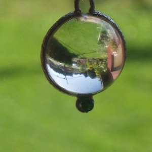 pools of light rock crystal  emerald accent  sterling bezel  sterling p chain