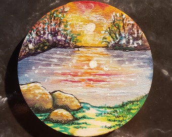 Handpainted Wooden Fridge Magnet of an Orange Golden Sunset over a Lake with Trees and Rocks