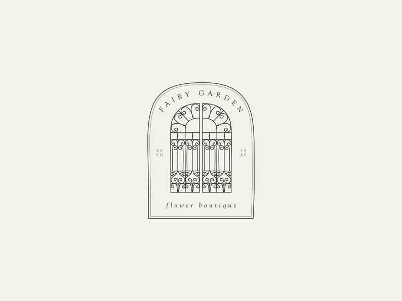 May include: Black and white line art illustration of a wrought iron gate with an arched top. The gate is labeled "Fairy Garden Flower Boutique" and "Est. 1980".