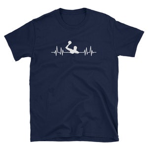 May include: A navy blue t-shirt with a white silhouette of a water polo player with a ball in their hand. The player is positioned above a white heartbeat graphic.