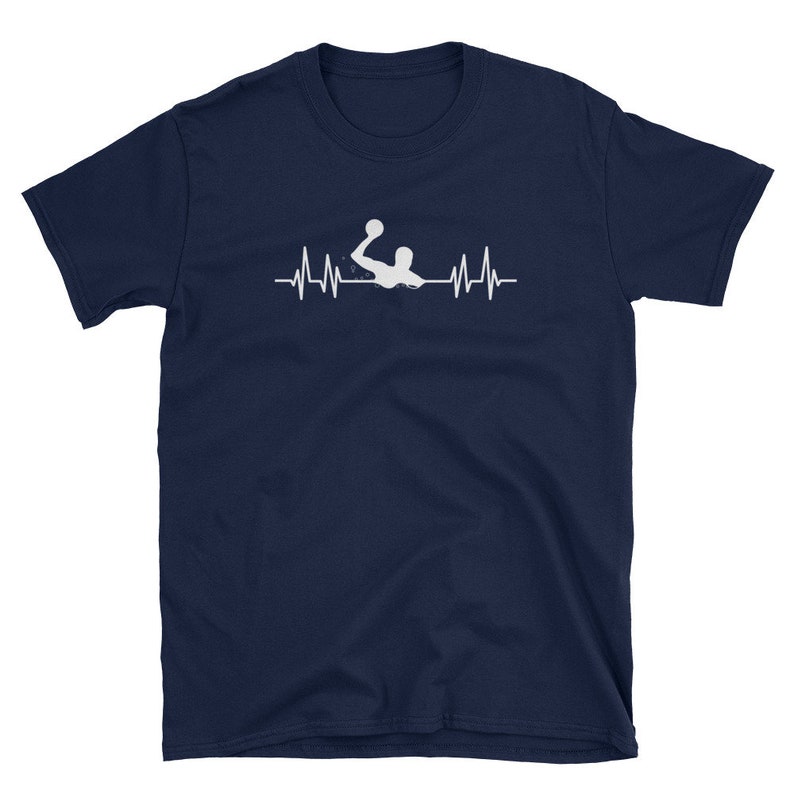 May include: A navy blue t-shirt with a white silhouette of a water polo player with a ball in their hand. The player is positioned above a white heartbeat graphic.