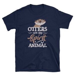 May include: Navy blue t-shirt featuring a cartoon otter illustration with the text "Otters are my spirit animal" in white and brown. The shirt is made of a soft material and is suitable for casual wear.
