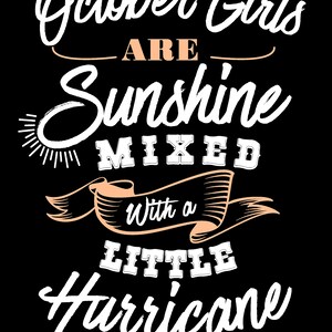 May include: Black graphic design with white and peach text that reads "October Girls are Sunshine Mixed With a Little Hurricane." The design includes a sun illustration and banner elements.