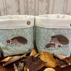 Fabric storage box or gift bag with machine embroidered hedgehog designs