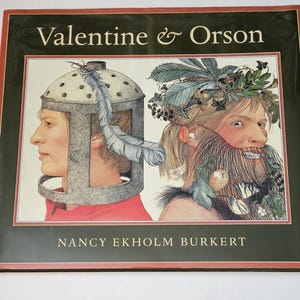 May include: A book cover with a green background and the title "Valentine & Orson" in white text. The cover features two illustrations of people, one wearing a helmet and the other with a crown of leaves. The author's name, "Nancy Ekholm Burkert", is printed in white text below the illustrations.