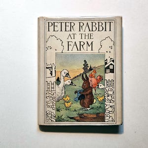 May include: A vintage hardcover book titled "Peter Rabbit at the Farm." The cover features an illustration of Peter Rabbit with other farm animals. The book has a cream-colored border with the title in black lettering.