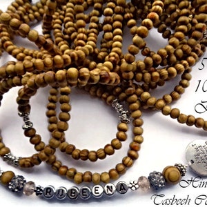 May include: A wooden prayer beads necklace with a silver charm and a personalised name charm. The necklace is made of 500 or 1000 beads and is available in a variety of colours. The necklace is a beautiful and meaningful gift for any occasion.