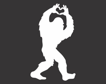 May include: A white silhouette of a Bigfoot figure on a dark gray background. The Bigfoot is walking with its arms raised, forming a heart shape with its hands. The image is a simple, graphic design.