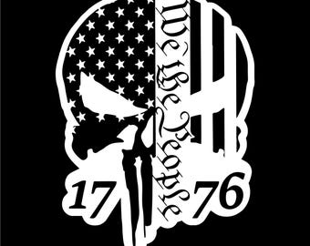 May include: A white graphic on a black background. The design is a skull with the American flag on the left side and the words "We the People" on the right. The numbers "17" and "76" are at the bottom.