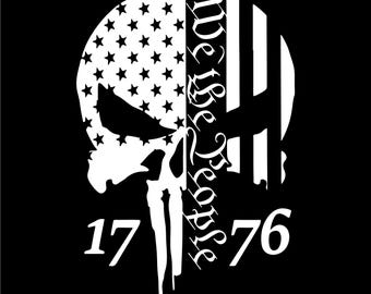 May include: A white skull design with the American flag on the left side and vertical stripes on the right. The words "We the People" are written vertically, with the numbers "17" and "76" below the skull, all on a black background.