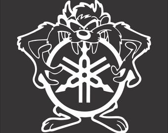 May include: A black and white illustration of a cartoon Tasmanian devil holding a Yamaha logo. The devil is wearing a menacing expression.