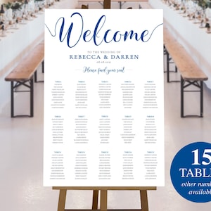 May include: A white wedding seating chart with blue text. The chart is titled "Welcome to the Wedding of Rebecca & Darren 08.05.2031". The chart lists 15 tables with guest names.