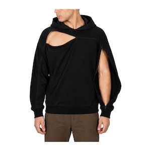 May include: A black long-sleeve hooded sweatshirt featuring a large asymmetrical cutout across the upper chest and a full-length zipper running along the outer seam of the left sleeve, creating an open design from the shoulder to the cuff.