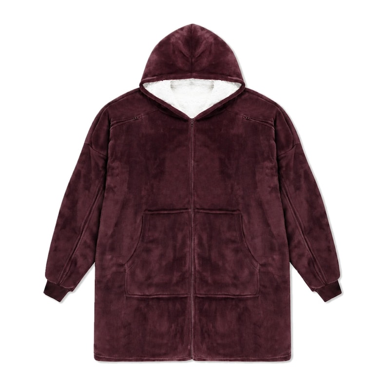 May include: A deep burgundy zip-up hoodie made of plush fleece material. This garment features a hood lined with white sherpa fabric, long sleeves with ribbed cuffs, and two large front pockets. The design includes a full-length front zipper.