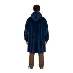 May include: A dark navy blue oversized hooded sweatshirt made of a plush, fuzzy fleece material. The garment features long sleeves with ribbed cuffs, a large hood, and a loose, knee-length fit that hangs straight down from the shoulders.