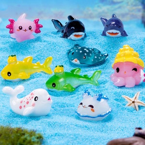 May include: A set of ten colorful miniature sea creatures, including a shark, a stingray, a dolphin, an octopus, and a starfish. The figurines are made of plastic and are perfect for decorating a miniature garden or terrarium.