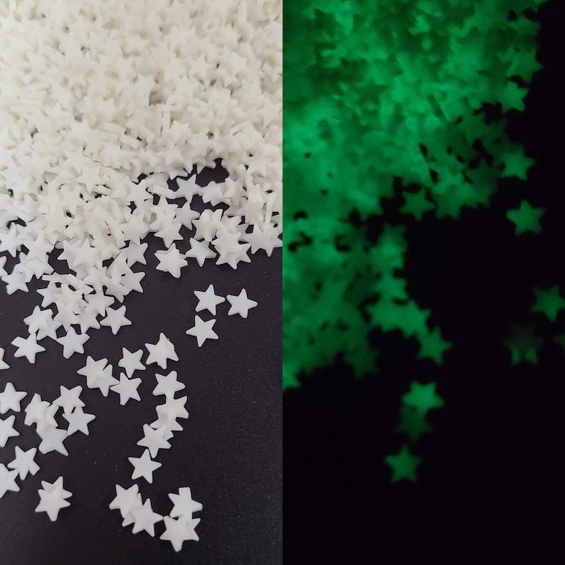 May include: A split image shows white star-shaped confetti and the same confetti glowing green. The white stars are scattered, while the green stars glow against a black background. The stars are small and appear to be made of plastic.