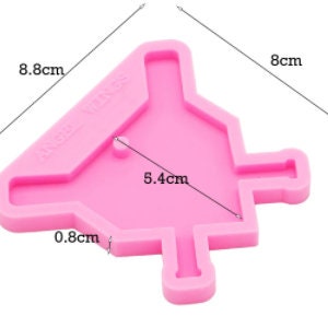 May include: Pink silicone mold shaped like a Christmas tree with a 5.4 cm wide opening and a 0.8 cm wide stem. The mold is 8 cm tall and 8.8 cm wide.