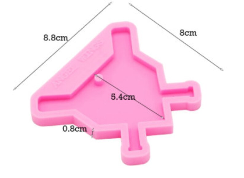 May include: Pink silicone mold shaped like a Christmas tree with a 5.4 cm wide opening and a 0.8 cm wide stem. The mold is 8 cm tall and 8.8 cm wide.