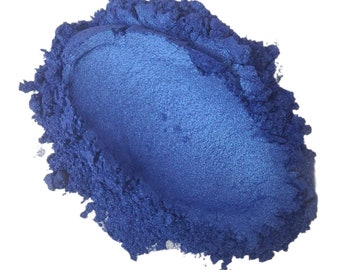 May include: A pile of blue mica powder. The powder is a fine, shimmery blue color and is perfect for adding a touch of sparkle to crafts and projects.