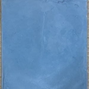 May include: A bag of light blue powder. The powder is smooth and uniform in texture.