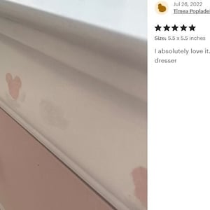 K&ouml;nnte beinhalten: Eine wei&szlig;e Kommode mit rosa Schubladen und Kristallkn&ouml;pfen. Die Kommode ist mit rosa Mickey Mouse-Aufklebern verziert. Die Kommode ist 5,5 Zoll mal 5,5 Zoll gro&szlig;.