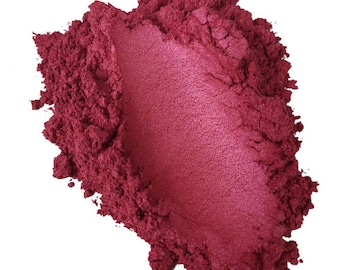 May include: A pile of deep red mica powder with a shimmery finish. The powder is loose and has a fine texture.