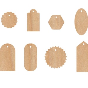 May include: Set of eight wooden gift tags in various shapes, including circles, ovals, rectangles, and a star. The tags are all natural wood colour and have a hole at the top for string or ribbon.