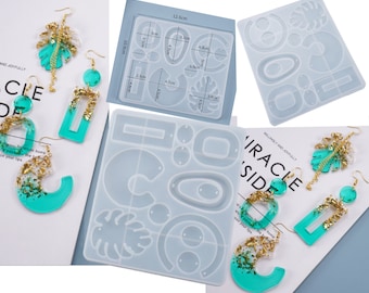 May include: Two silicone molds for making resin earrings. The molds feature various shapes, including circles, ovals, and leaves. The molds are 12.6 cm by 10.9 cm.  The image also shows several finished resin earrings in turquoise and gold.
