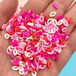 Peut inclure: Un grand tas de vermicelles en forme de lèvres roses, rouges et blanches. Les vermicelles sont faits d'un matériau souple et malléable et sont parfaits pour décorer les gâteaux, les cupcakes et autres desserts.