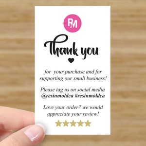 May include: Thank you card with a pink circle containing the letters RM. The card says "Thank you" with a black heart below the text. The card also says "for your purchase and for supporting our small business! Please tag us on social media @resinmoldca #resinmoldca Love your order? we would appreciate your review!" with five gold stars below the text.