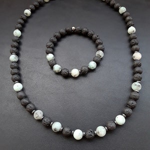 May include: A set of black lava rock and green gemstone beads, one necklace and one bracelet. The necklace has a silver clasp.
