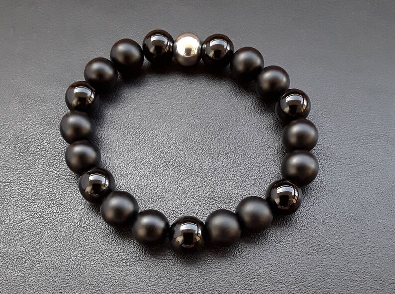 May include: A black onyx beaded bracelet with a silver bead accent.