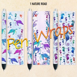 May include: Three pen wraps with a seahorse and turtle design. The wraps are white with blue, green, and purple seahorses and turtles. The text "Pen Wraps" is in yellow and the text "1 Nature Road" is in black.