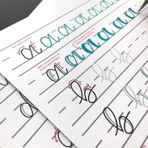 May include: A worksheet with instructions on how to write the letter "a" in cursive. The instructions include "Start with monoline" and "Add a second line to all of your downstrokes". The worksheet shows examples of how to write the letter "a" in different styles.