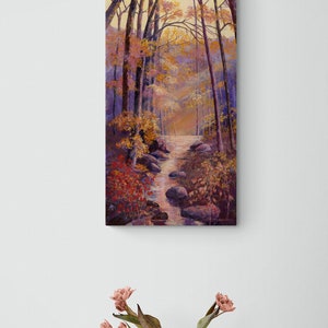 May include: A painting of a forest path with a stream running through it. The trees are mostly bare, but some have leaves in shades of red, orange, and yellow. The stream is clear and flowing over rocks. The painting is done in a realistic style.