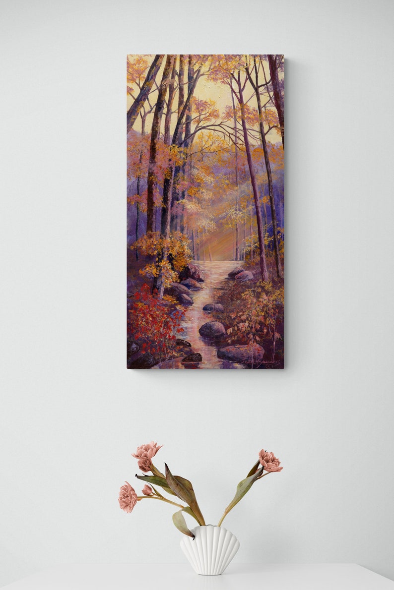 May include: A painting of a forest path with a stream running through it. The trees are mostly bare, but some have leaves in shades of red, orange, and yellow. The stream is clear and flowing over rocks. The painting is done in a realistic style.