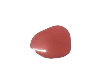 May include: A single drop of coral-colored nail polish on a white background.