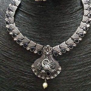 Bib necklace/German silver/oxidized/boho/silver look alike peacock design necklace set with matching jhumkas in colored stones