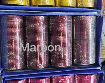 May include: Three stacks of gold, maroon, and pink bangles with gold glitter. The stacks are labeled "Yellow", "Maroon", and "Pink".