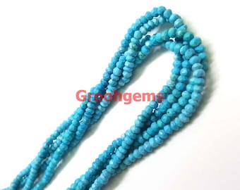 May include: A strand of turquoise blue gemstone beads, each bead is faceted and has a pointed shape. The beads are strung together on a clear thread.