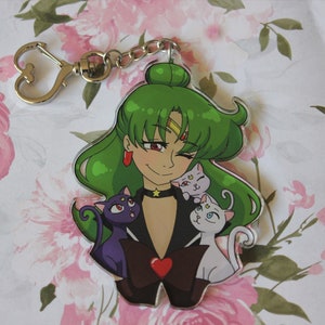 May include: A green-haired anime character with a black choker and a red heart on her chest. She is surrounded by three cats, one black, one white, and one light gray.