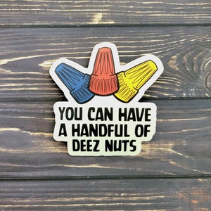 May include: A white sticker with three wire connectors in red, blue, and yellow. The text "You can have a handful of Deez Nuts" is printed in black.