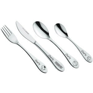 May include: A set of four stainless steel children's cutlery with the name "Charly" engraved on each piece. The knife has the text "18/10  ROSTFREI" engraved on the blade. The fork, knife, and two spoons feature different Peanuts characters.