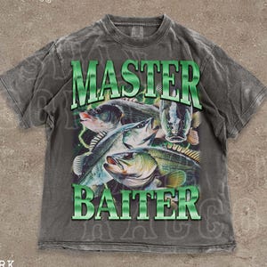 A grey t-shirt with a graphic design featuring a fish and the text "MASTER BAITER" printed on it.