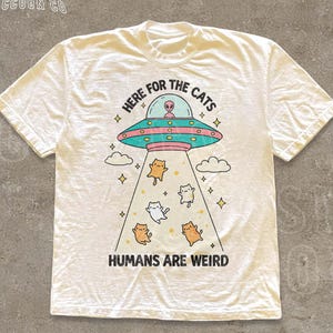 Funny Cat Shirt Here For The Cats Humans Are Weird Vintage Cartoon Tee Alien UFO Cat Lover Gift Retro Pastel Graphic Unisex T Shirt