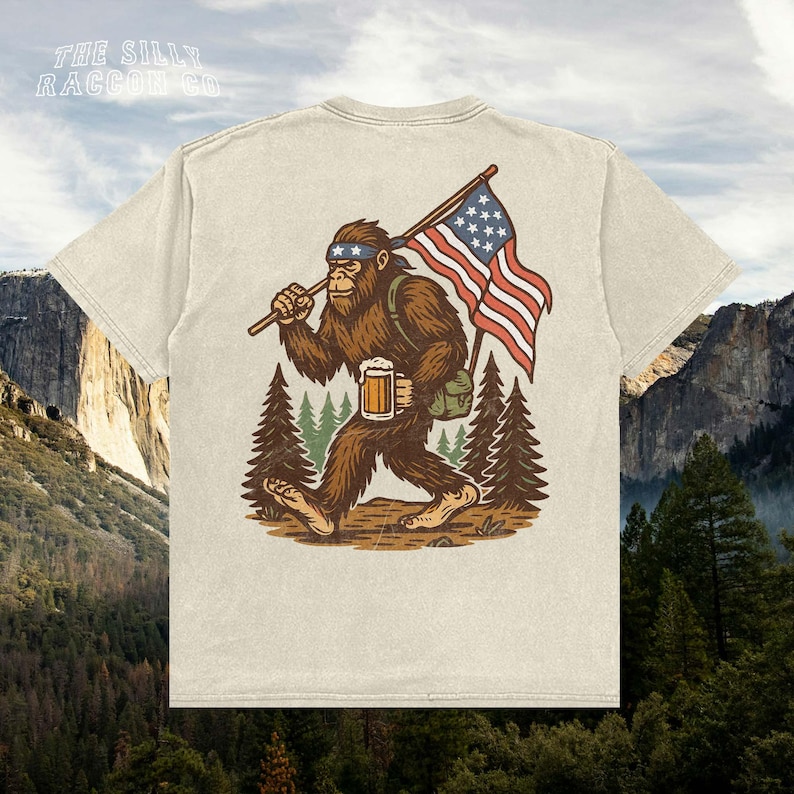 a t - shirt with a picture of a bigfoot holding a flag