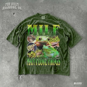 A green t-shirt with a graphic design featuring multiple images of frogs.