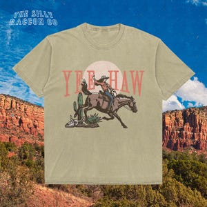a t - shirt with a cowboy riding a horse