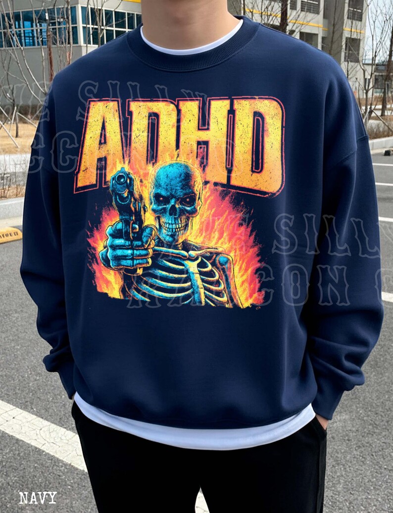 A navy blue sweatshirt with a graphic design depicting a skeleton holding a gun, with flames behind the skeleton.